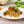 Spaghetti with Italian Style Vince on a white plate with vegetables in the background.  Healthy, quick, family meal using Vince’s hidden veggie mix, served with whole ingredients — perfect for picky eaters